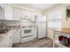 Bright white kitchen features granite countertops and modern appliances at 4239 Tamargo Dr, New Port Richey, FL 34652