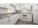 Kitchen with white cabinets, granite countertops and modern appliances at 4239 Tamargo Dr, New Port Richey, FL 34652