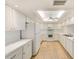 Modern kitchen featuring white cabinets and new flooring at 736 Island Way # 404, Clearwater Beach, FL 33767