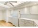 White kitchen with stainless steel appliances and wood-look floors at 736 Island Way # 404, Clearwater Beach, FL 33767