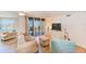 Bright living room with water views, comfy seating, and light wood floors at 736 Island Way # 404, Clearwater Beach, FL 33767