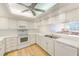 Bright kitchen with white cabinets and stainless steel appliances at 736 Island Way # 404, Clearwater Beach, FL 33767