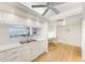 Bright eat-in kitchen with white cabinets, and view to living room at 736 Island Way # 404, Clearwater Beach, FL 33767