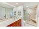 Bathroom with updated vanity and walk-in shower at 736 Island Way # 404, Clearwater Beach, FL 33767