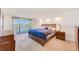 Spacious main bedroom with water views and wood furniture at 736 Island Way # 404, Clearwater Beach, FL 33767