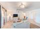 Open living area with light flooring and access to balcony at 736 Island Way # 404, Clearwater Beach, FL 33767