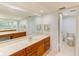 Double vanity bathroom with marble countertop and separate toilet at 736 Island Way # 404, Clearwater Beach, FL 33767
