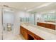 Double vanity bathroom with marble countertop and separate toilet at 736 Island Way # 404, Clearwater Beach, FL 33767