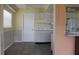Kitchen with white cabinets, appliances and a view to the dining area at 4251 100Th N Ave # 2, Pinellas Park, FL 33782