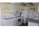 Kitchen with white cabinets, appliances, and a double sink at 4251 100Th N Ave # 2, Pinellas Park, FL 33782