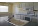White kitchen with double sink, built-in microwave, and an electric range at 4251 100Th N Ave # 2, Pinellas Park, FL 33782