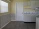 Kitchen area with white cabinets, a double sink, and a door at 4251 100Th N Ave # 2, Pinellas Park, FL 33782