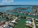 Bird's-eye view of waterfront community, showcasing many homes at 309 Belle Isle Ave, Belleair Beach, FL 33786