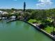 Aerial view of waterfront home with private dock and lush landscaping at 309 Belle Isle Ave, Belleair Beach, FL 33786