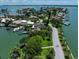 Luxury waterfront home with private dock and lush landscaping at 309 Belle Isle Ave, Belleair Beach, FL 33786