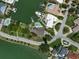 Aerial view of waterfront home with pool and private dock at 309 Belle Isle Ave, Belleair Beach, FL 33786