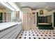 Spa-like bathroom with double vanity and a large tub at 309 Belle Isle Ave, Belleair Beach, FL 33786