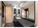 Bathroom with black countertop and large mirror at 309 Belle Isle Ave, Belleair Beach, FL 33786