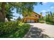 Two-story home with double garage and lush landscaping at 309 Belle Isle Ave, Belleair Beach, FL 33786