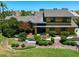 Two-story house with landscaping and a yellow exterior at 309 Belle Isle Ave, Belleair Beach, FL 33786