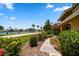 Landscaped walkway leading to home's entrance with water views at 309 Belle Isle Ave, Belleair Beach, FL 33786