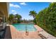 Inviting pool area with lush landscaping and patio at 309 Belle Isle Ave, Belleair Beach, FL 33786