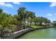 Canal-front property with lush landscaping and mature trees at 309 Belle Isle Ave, Belleair Beach, FL 33786
