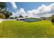 Large backyard features lush green lawn, a private patio, and attractive exterior at 3931 38Th S Way, St Petersburg, FL 33711