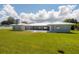 Spacious backyard with lush lawn, patio area, and charming single-story home at 3931 38Th S Way, St Petersburg, FL 33711