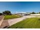 Exterior view of a single-story home with a long driveway and a metal roof at 3931 38Th S Way, St Petersburg, FL 33711