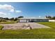 Single story home with a large driveway, attached garage, and well-maintained lawn at 3931 38Th S Way, St Petersburg, FL 33711