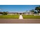 Charming single-story home featuring a metal roof, well-manicured lawn, and inviting walkway at 3931 38Th S Way, St Petersburg, FL 33711