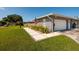 Beautifully landscaped single-story home featuring a garage and an American flag at 3931 38Th S Way, St Petersburg, FL 33711