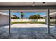Covered outdoor patio with tiled floor and view of private backyard with lush landscaping at 3931 38Th S Way, St Petersburg, FL 33711