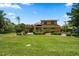 Two-story home with lush landscaping and a large lawn at 309 Belle Isle Ave, Belleair Beach, FL 33786
