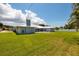 Large backyard with lush grass and a modern home at 3931 38Th S Way, St Petersburg, FL 33711