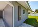 Outdoor shower with modern gray siding and stone tile flooring at 3931 38Th S Way, St Petersburg, FL 33711