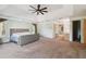 Main bedroom with carpet, ceiling fan and access to bathroom and closet at 6109 Waters Way, Weeki Wachee, FL 34607