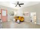 Living room featuring a mustard yellow couch and light gray walls at 6490 34Th N Ave, St Petersburg, FL 33710