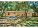 Backyard with patio, mature trees, and grassy area at 6490 34Th N Ave, St Petersburg, FL 33710