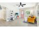 Bright living room with yellow couch, large TV, and wood-look floors at 6490 34Th N Ave, St Petersburg, FL 33710