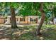 House with a tree-lined front yard at 6490 34Th N Ave, St Petersburg, FL 33710