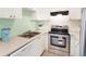 Modern kitchen with stainless steel appliances and light green accent wall at 6490 34Th N Ave, St Petersburg, FL 33710