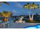 Lighted walkway leads to a relaxing patio and pool area at 4 Treasure Ln, Treasure Island, FL 33706