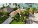 Aerial view showing home, landscaping, and paved driveway at 4 Treasure Ln, Treasure Island, FL 33706