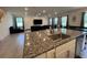 Kitchen island with granite countertop and stainless steel sink at 18225 Mairdale Rd, Weeki Wachee, FL 34614