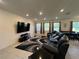 Living room with sectional sofa and large TV at 18225 Mairdale Rd, Weeki Wachee, FL 34614