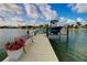 Private dock with a bench, boat lift, and beautiful waterfront views at 4 Treasure Ln, Treasure Island, FL 33706