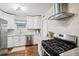 Modern kitchen with stainless steel appliances and white cabinetry at 1762 New Hampshire Ne Ave, St Petersburg, FL 33703