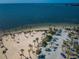 Expansive aerial view of the beach, showcasing turquoise waters, sandy shores, and palm trees at 1032 Rosetree Ln, Tarpon Springs, FL 34689